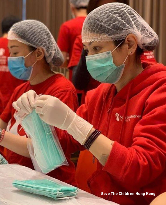 A volunteer puts together care packages