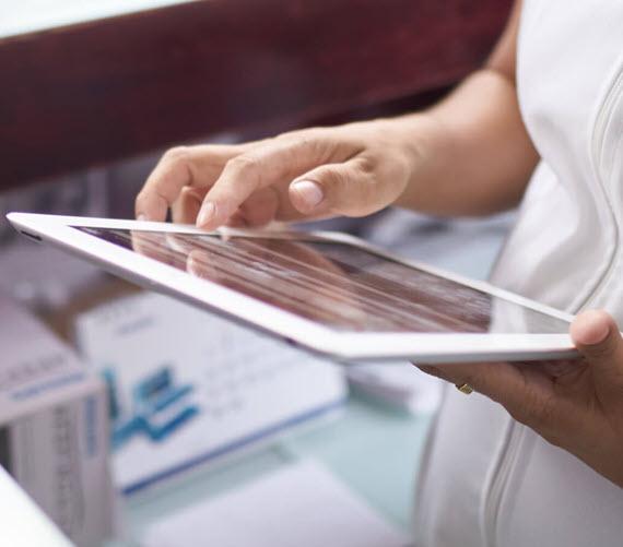 Image of nurse holding a tablet device